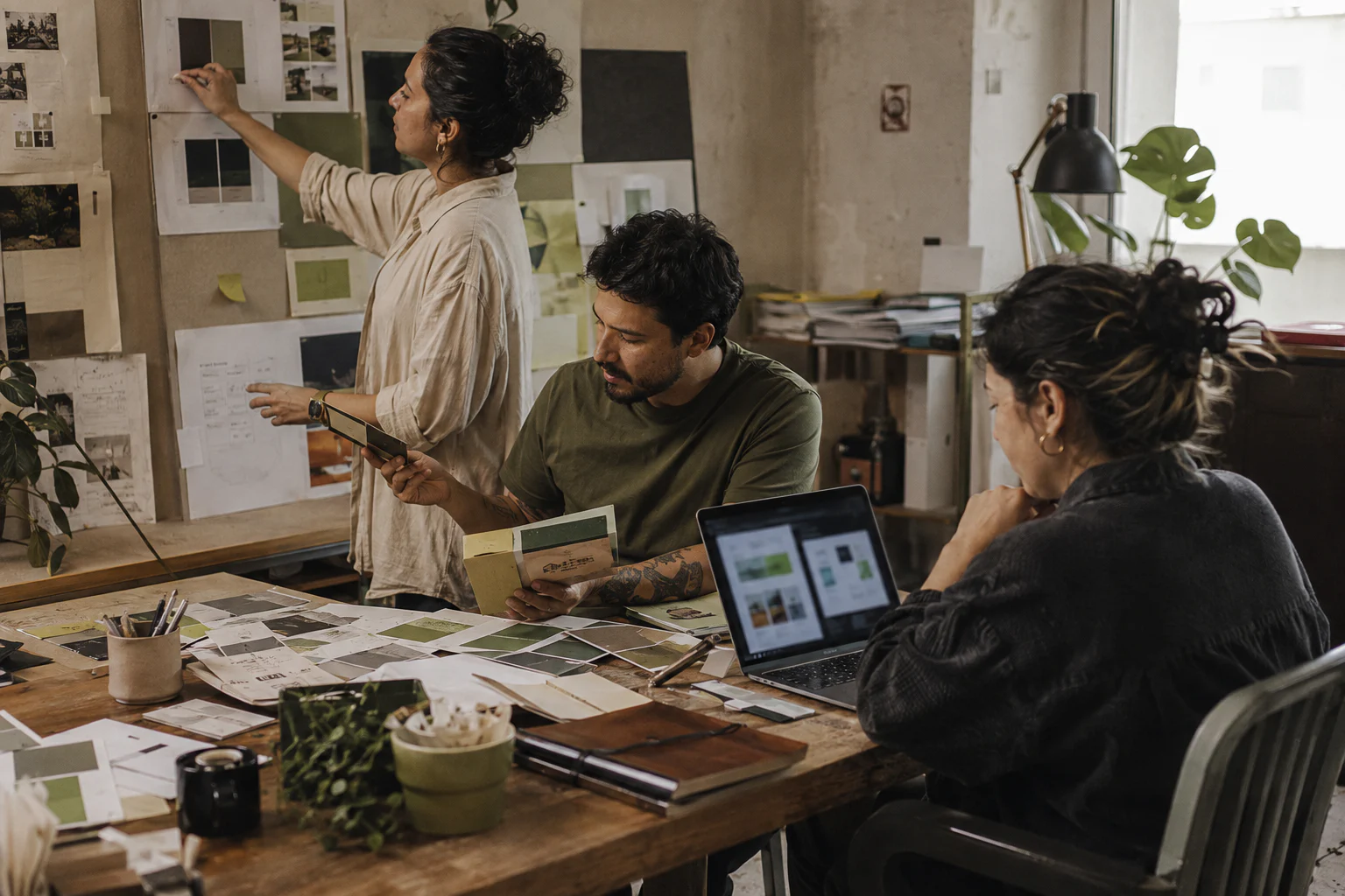 Three creative professionals review identity samples and decisions in the Grubbx studio.